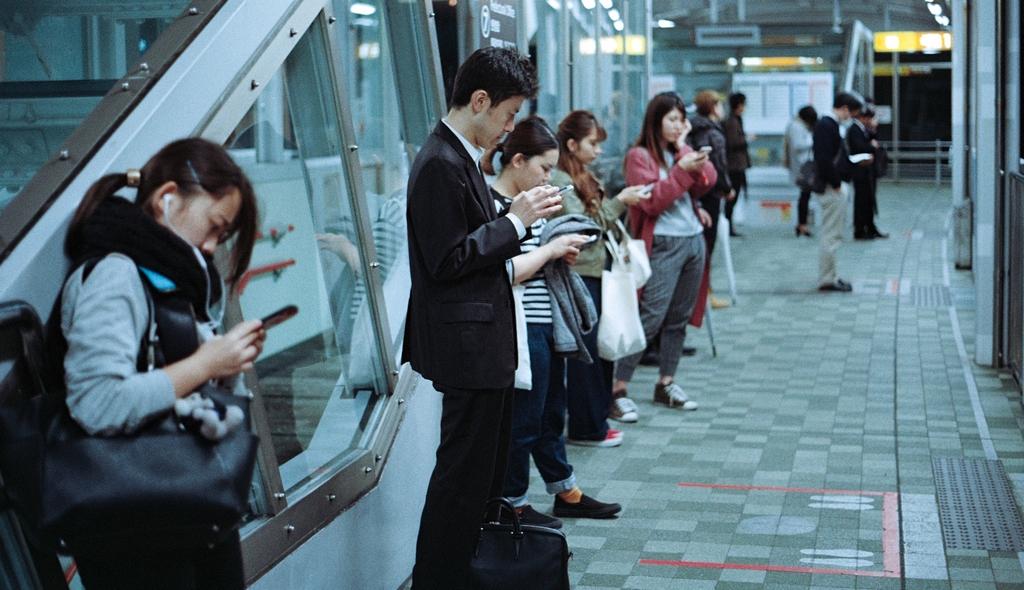 Subway commuters using mobile devices